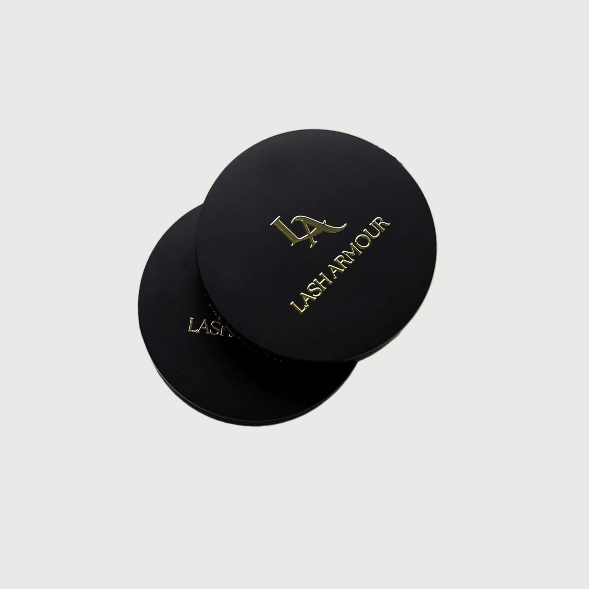 Eyelash extensions with open cases and a pair of scissors on a white background
