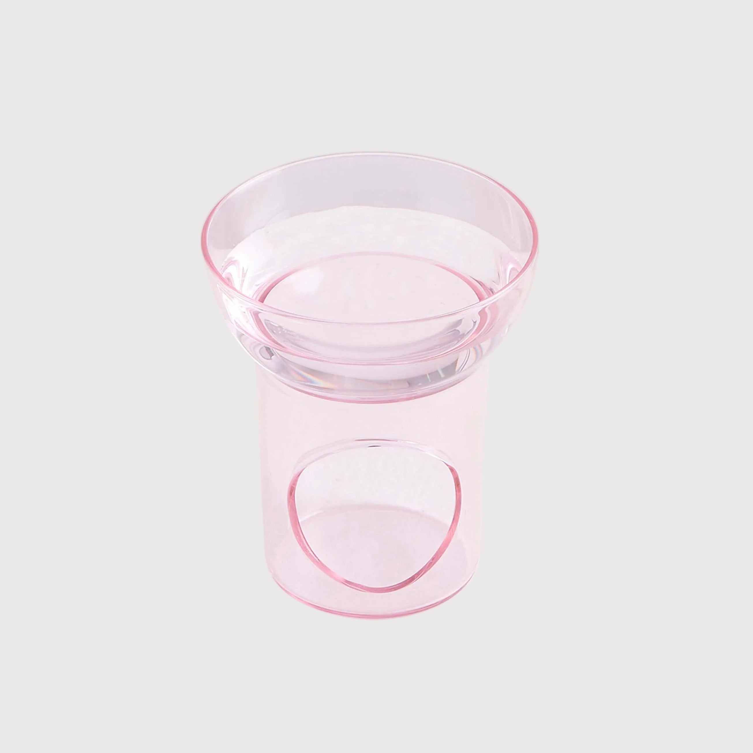 Clear glass bowl with pink rim on a white background