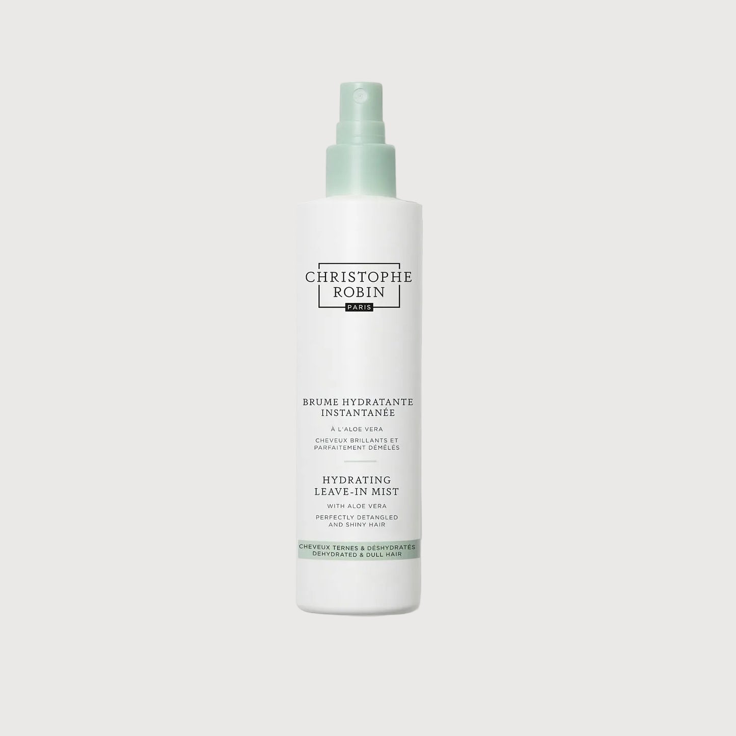 White spray bottle with green label on a white background