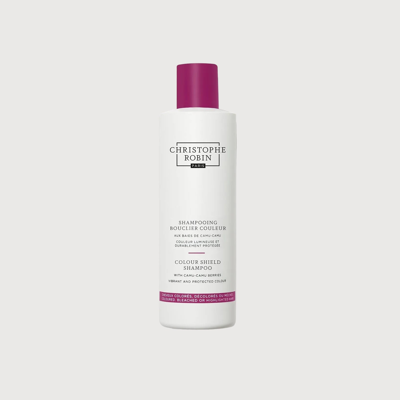 White shampoo bottle with purple cap on a white background