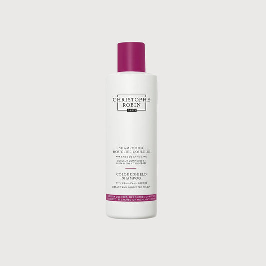 White shampoo bottle with purple cap on a white background