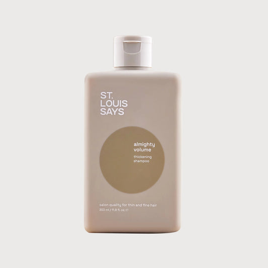 Shampoo bottle labeled 'St. Louis Says' on a light background
