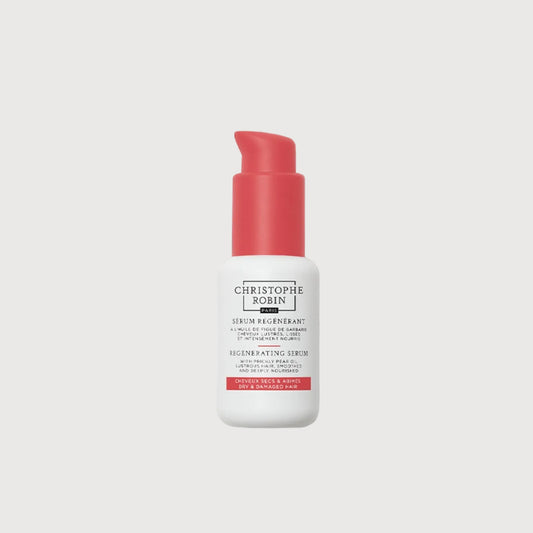 Skincare serum bottle with red cap and white label on a white background