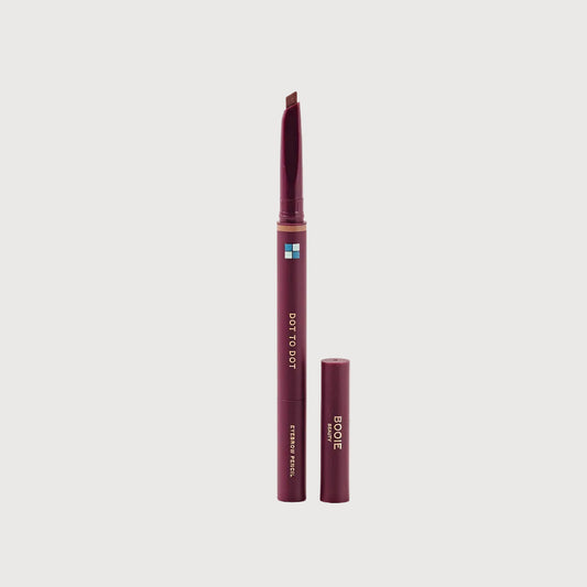 Brow pencil with cap on a light pink background