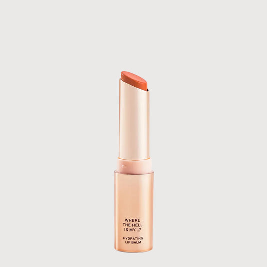Lip balm with orange cap and visible text on a light gray background