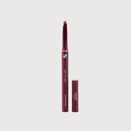 Eyebrow pencil with cap on a light pink background