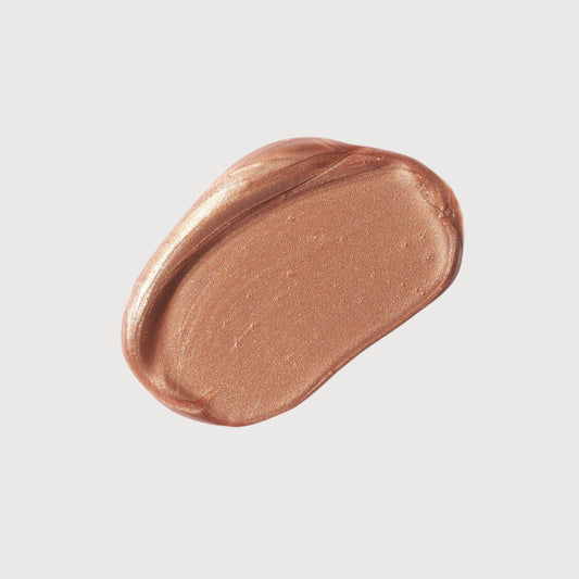 Bronze-colored makeup swatch on a light gray background