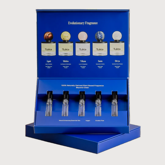 Display of Evolutionary Fragrance bottles with labels on a blue stand.