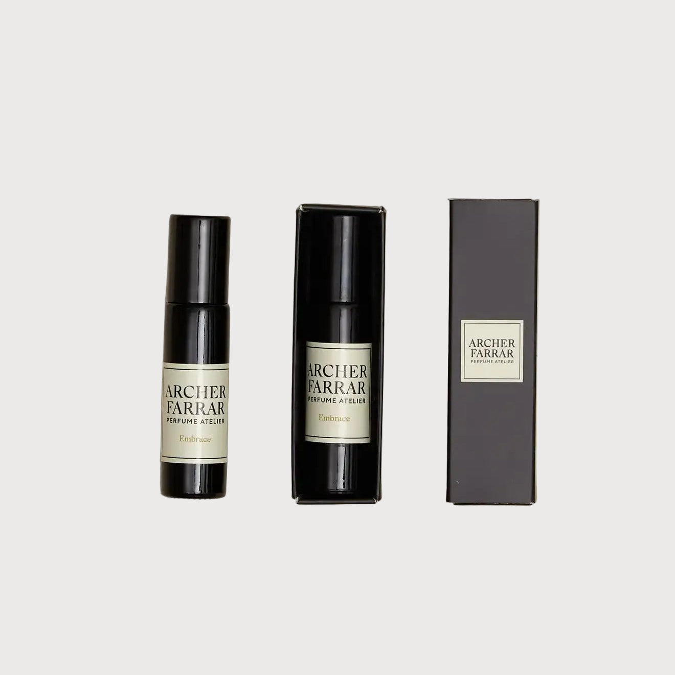 Two Archer Parker perfume bottles and their packaging on a textured beige surface