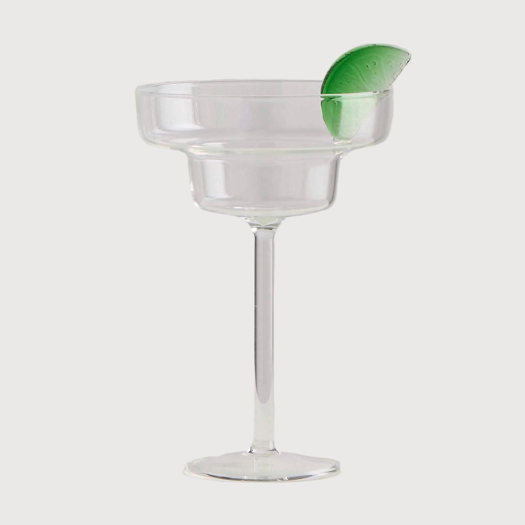 Clear glass with a green leaf on a white background
