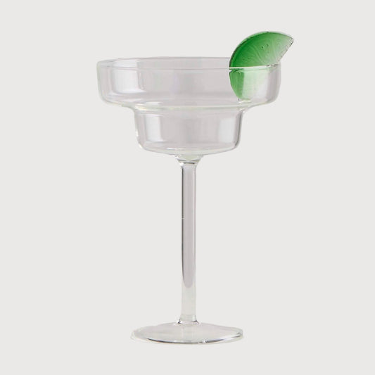 Clear glass with a green leaf on a white background