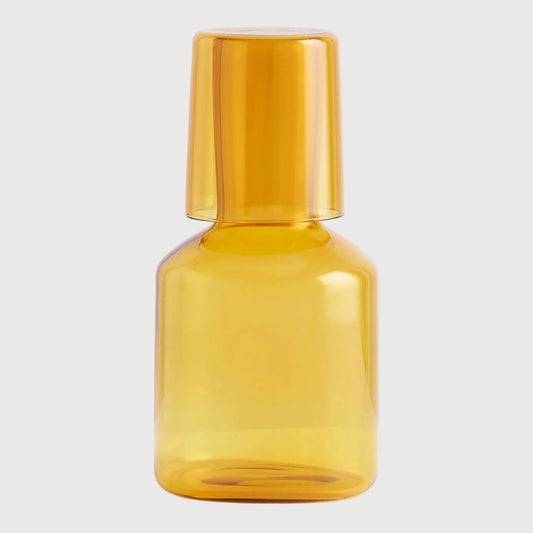 Amber glass bottle on a light gray background