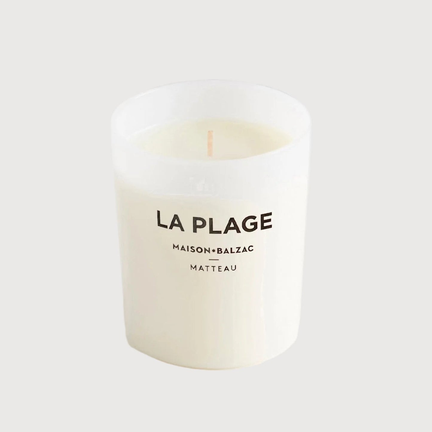Candle labeled 'La Plage' by Maison Balzac on a white background