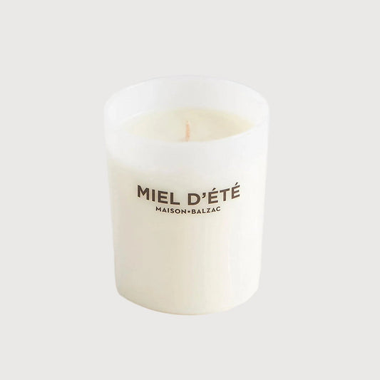 White candle with text on a white background