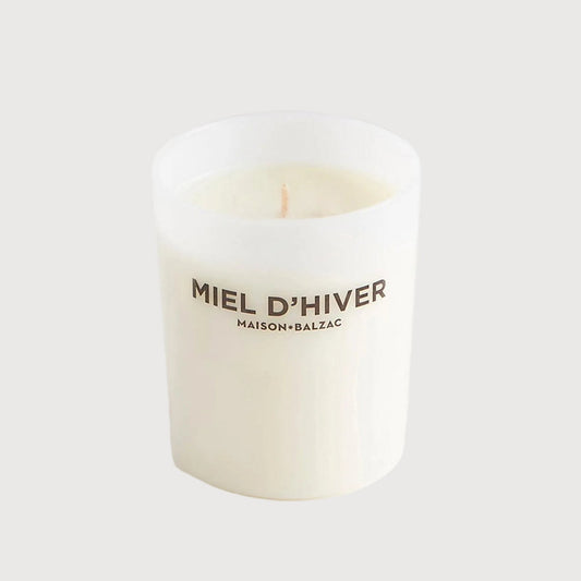 White candle with 'MIEL D'HIVER' text on a white background