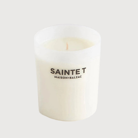 White candle with 'SAINTE T' branding on a white background