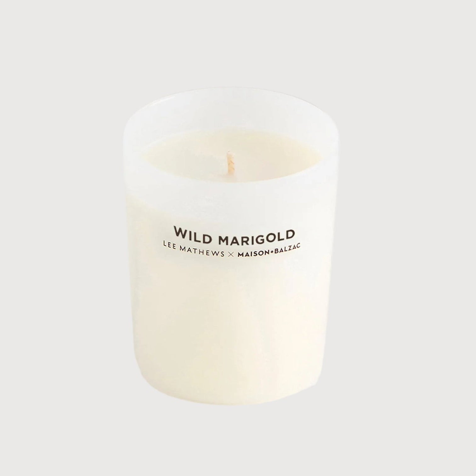 White candle with 'Wild Marigold' text on a white background