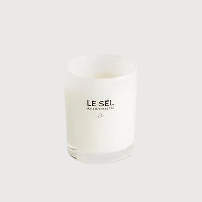 White candle with 'LE SEL' branding on a white background