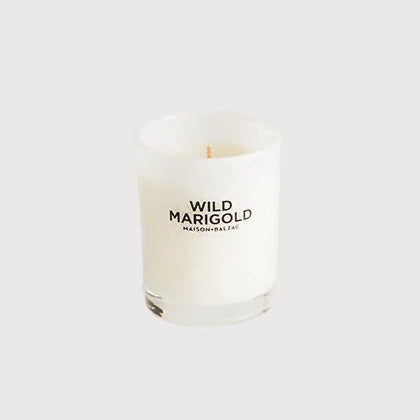Candle with 'Wild Marigold' branding on a white background