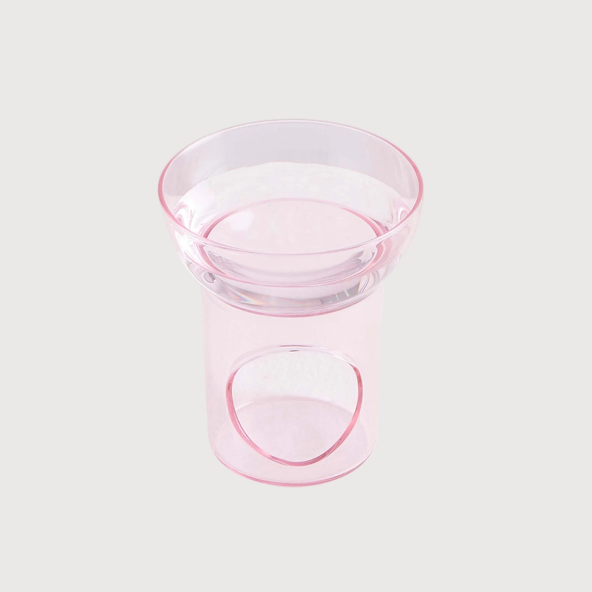 Clear glass bowl with pink rim on a white background