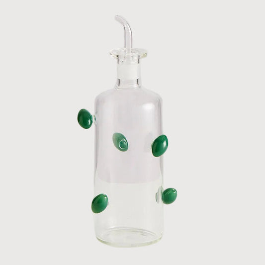 Clear glass bottle with green accents on a white background
