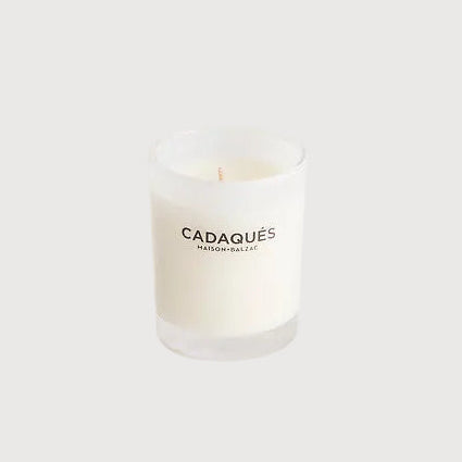 Candle with 'Cadaqués' branding on a white background