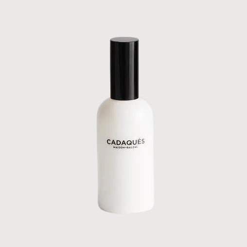 White bottle with black cap on a light gray background