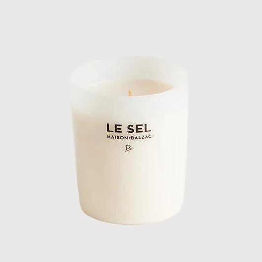 White candle with 'LE SEL' branding on a white background