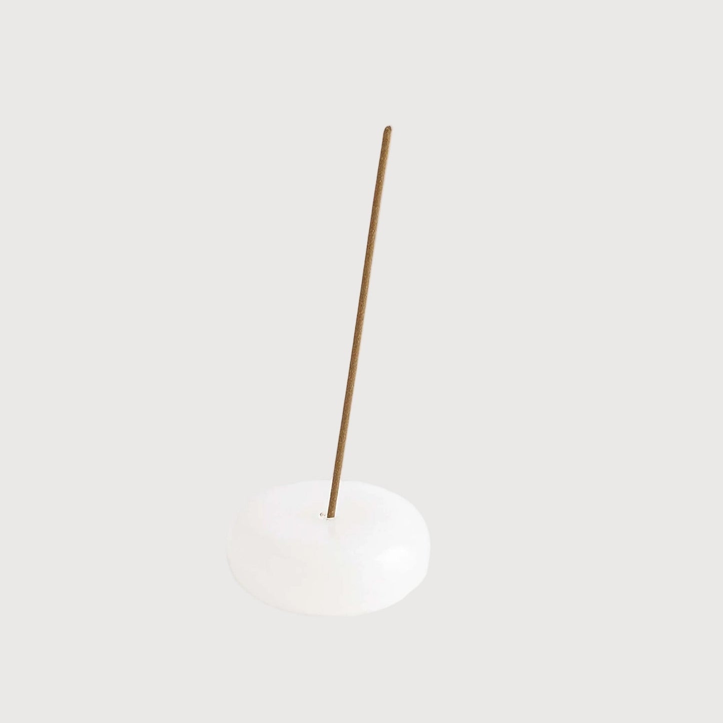 Minimalist pendant light with a white shade and gold fixture on a white background