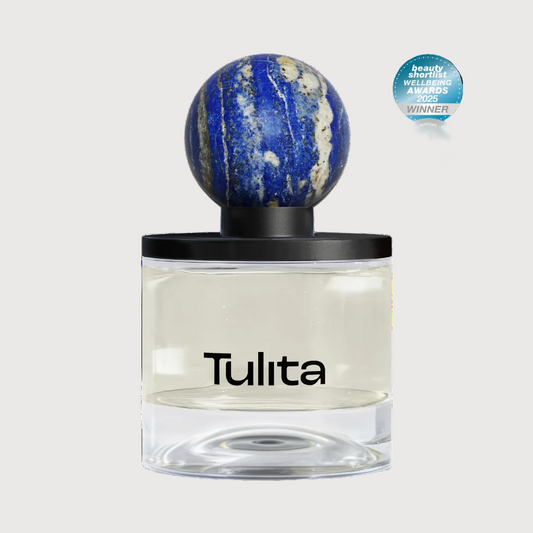 Tulita perfume bottle with a decorative cap on a white background