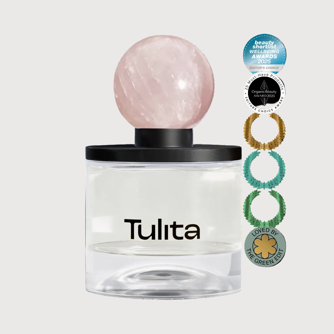 Tulita perfume bottle with a pink crystal cap on a white background