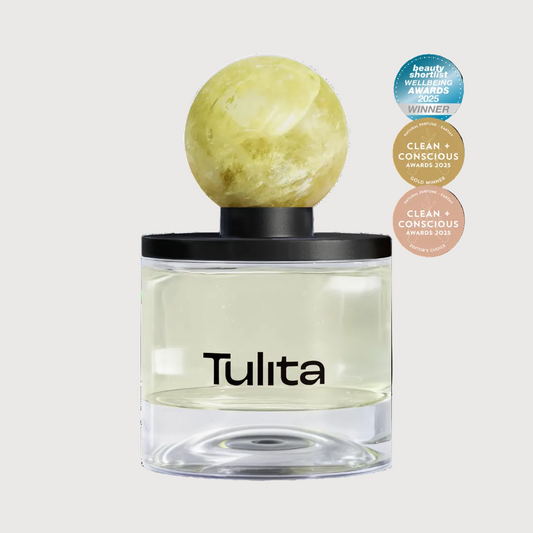 Tulita perfume bottle with a spherical green cap on a white background