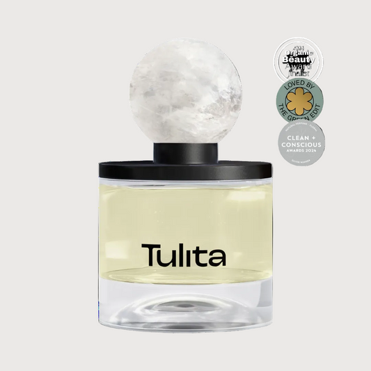 Perfume bottle labeled 'Tulita' with decorative cap on a white background