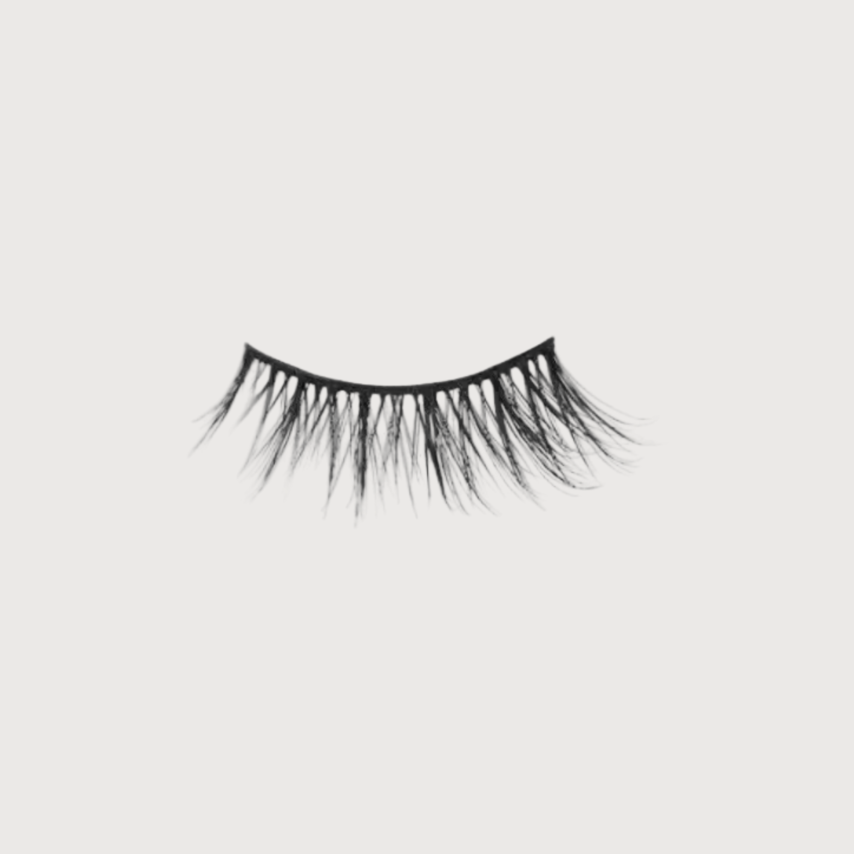 Pair of false eyelashes on a light gray background
