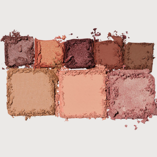 Makeup eyeshadow palette with various shades on a white background