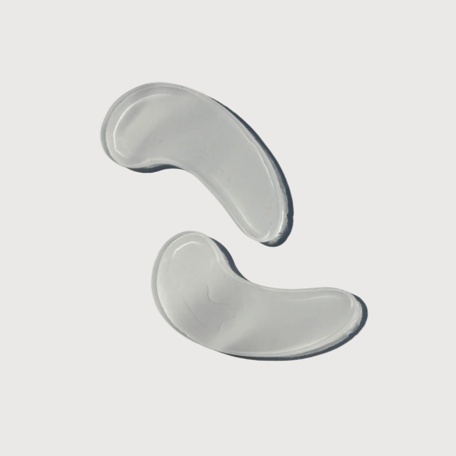 Two gray silicone gel pads on a white background