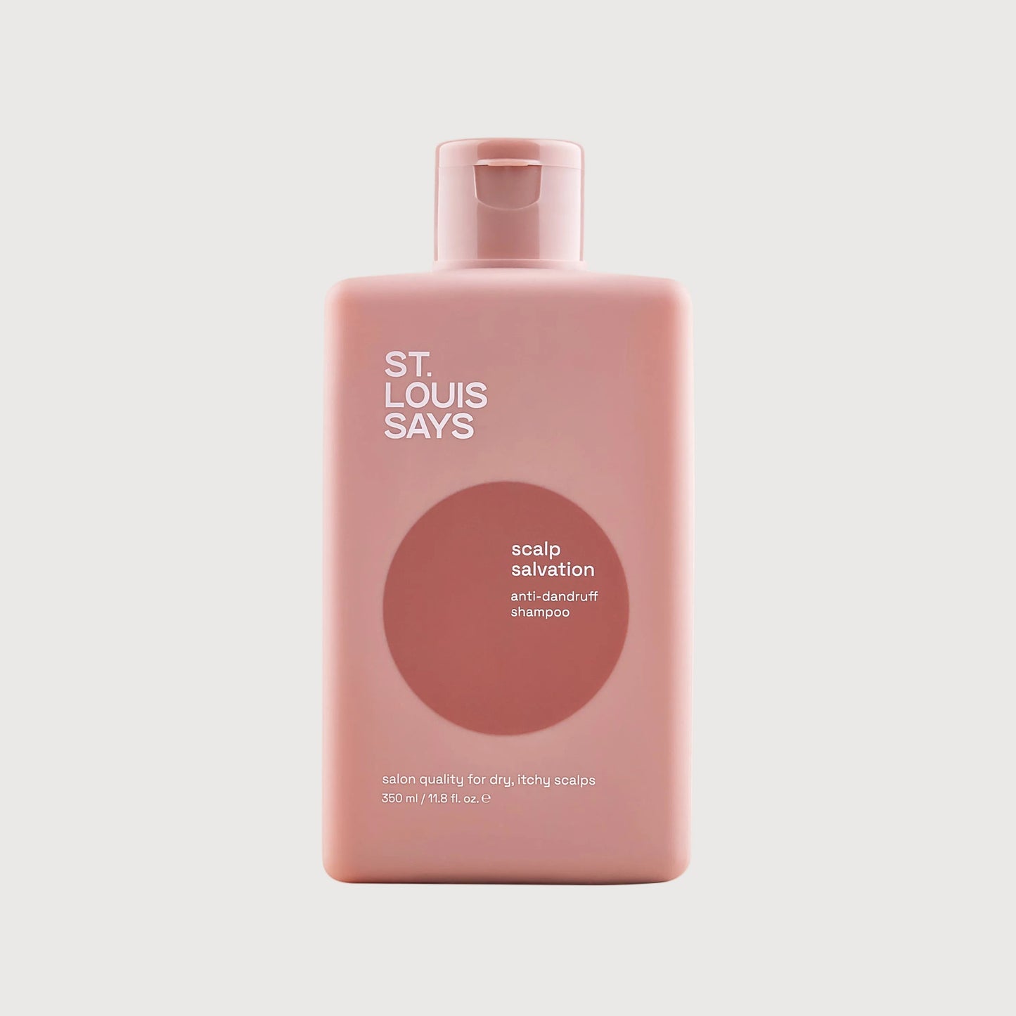 Pink bottle of 'St. Louis Says' scalp salvation product on a light gray background
