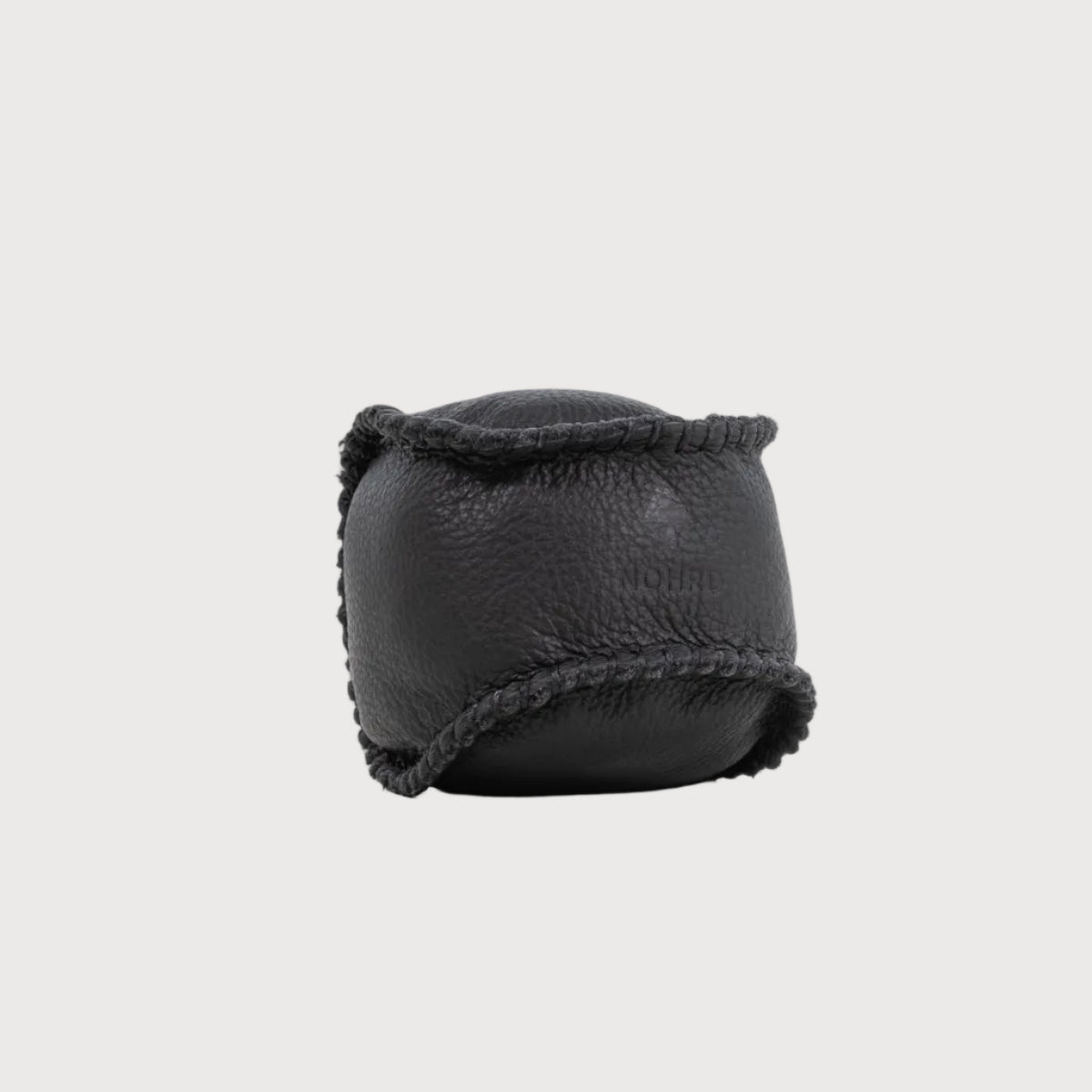 Black leather product with textured surface on a white background