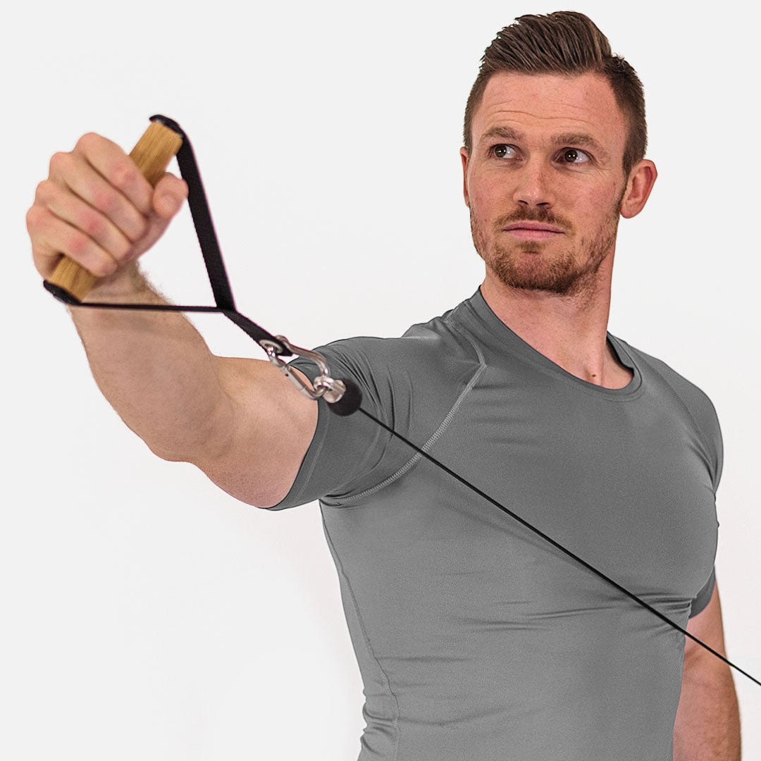 Man using a resistance band for exercise on a white background