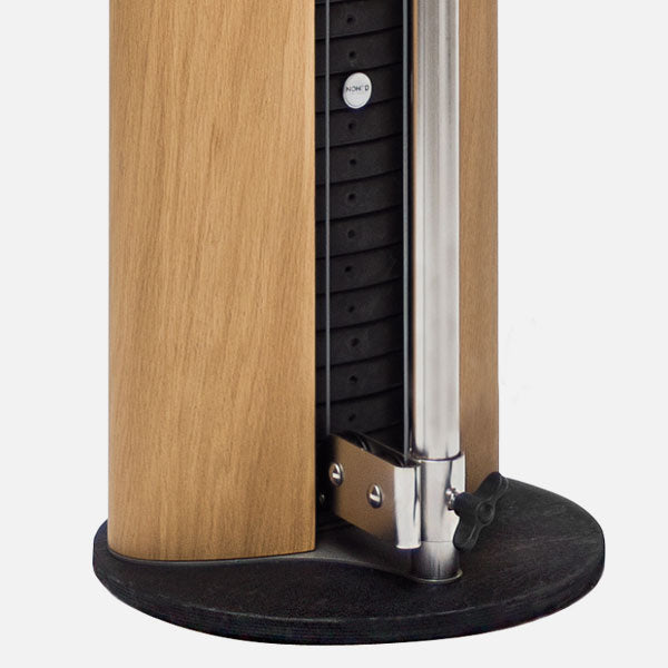 Close-up of a wooden speaker with metal and black components on a white background