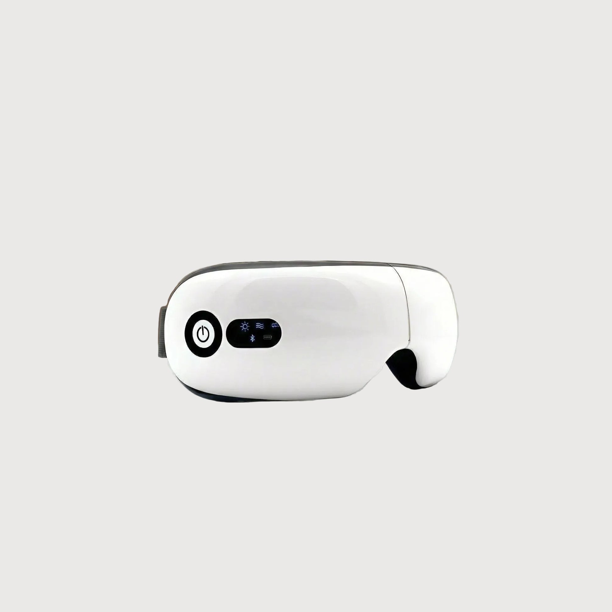 White robot on a table with a blurred living room background